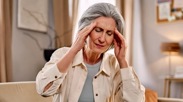 жінка з напруженим виразом обличчя через головний біль як ілюстрація до сторінки про консультацію невролога при головному болю у клініці Медонія Прайм у Хмельницькому